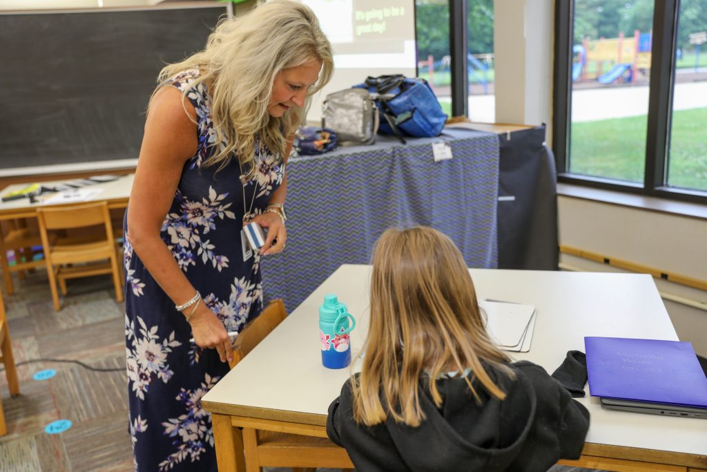 teacher helping student
