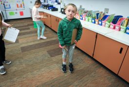 Smiling boy in classroom.