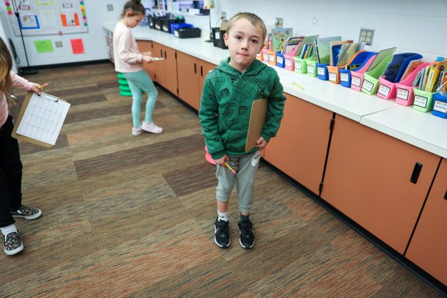 Smiling boy in classroom.