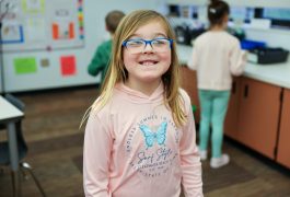 Smiling girl in classroom.